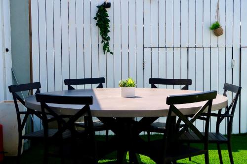 a table with chairs and a potted plant on it at Cancun in Netanya