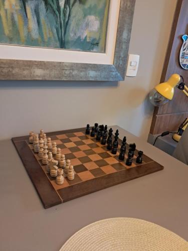 a chessboard on a table in a room at Home Batel in Curitiba
