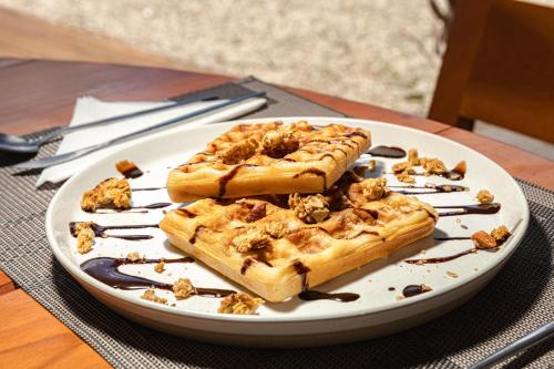 Ein weißer Teller mit zwei Stücken Kuchen auf einem Tisch in der Unterkunft Alma Maya Resort - Riviera Maya in Puerto Morelos