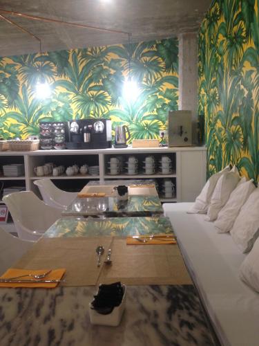 a dining room with a table and a wall with plants at Hotel Art Santander in Santander