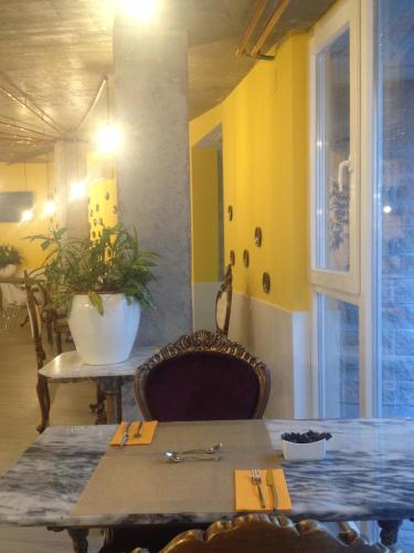 a dining room with a table and a yellow wall at Hotel Art Santander in Santander