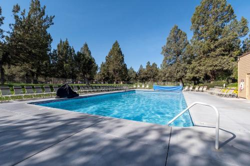 a swimming pool with trees in the background at Canyon Rim at Eagle Crest in Redmond