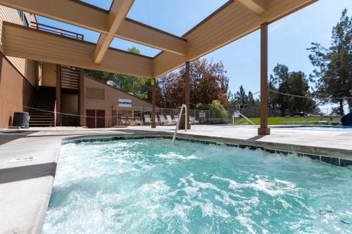 a large swimming pool with a pergola at Canyon Rim at Eagle Crest in Redmond