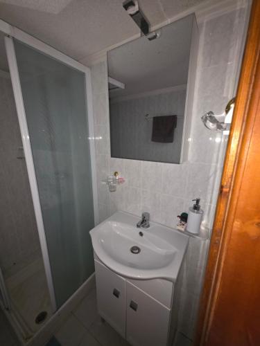 a bathroom with a sink and a shower at Pati's summer house in Siviri