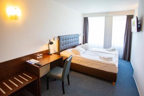 Postel nebo postele na pokoji v ubytování Hotel CHODOV ASC