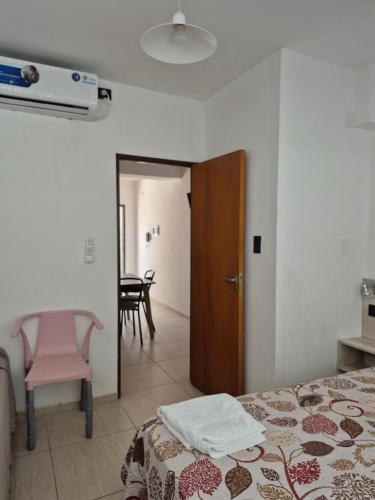 a bedroom with a bed and a table and a chair at pedro de valdivia 219 oeste in San Juan