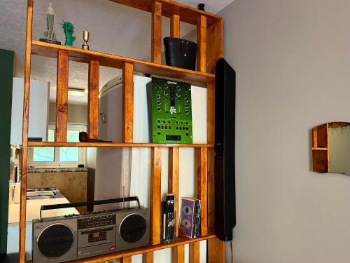 a book shelf with a radio on top of it at Spin Inn in Kotor
