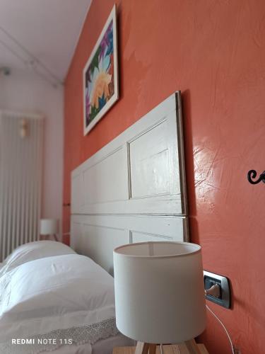 a bedroom with a bed with a white headboard at TORRACCHIONE House in Barberino di Mugello
