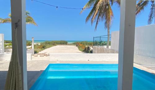 a view of a swimming pool from a house at Beachfront house with pool in Progreso