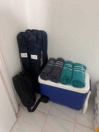 a room with a suitcase and towels and a bag at Casa Rosado Villa Marina Fajardo Yunque Seven Seas in Fajardo