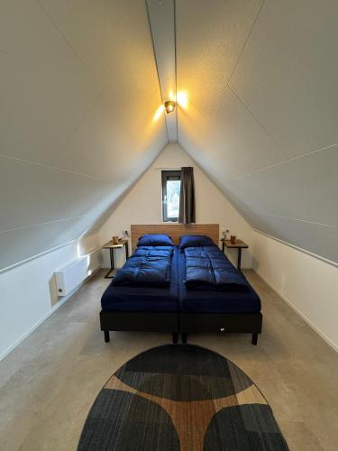 a bedroom with a bed in a attic at Enkhuizer Strand BeachHouse Sonnendeck Nr 414 in Enkhuizen