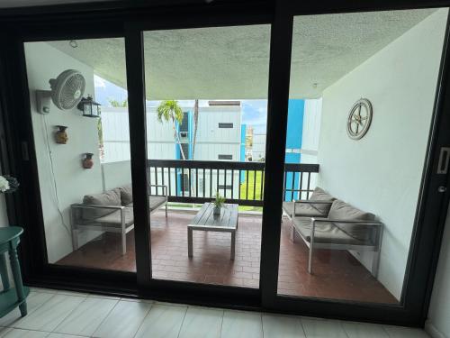 a view of a living room with sliding glass doors at Casa Rosado Villa Marina Fajardo Yunque Seven Seas in Fajardo