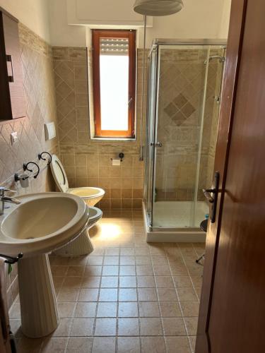a bathroom with a sink and a shower and a toilet at Casa sul mare in Vibo Valentia Marina