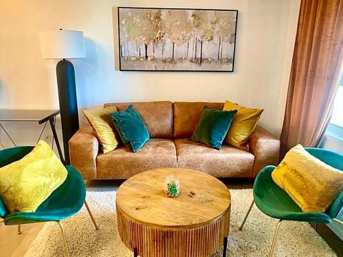 a living room with a couch and a table and chairs at City Center Olive Grove in Kamloops