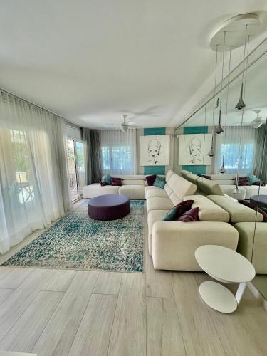 a living room with a couch and a table at S'agaró Mar in Sant Feliu de Guíxols