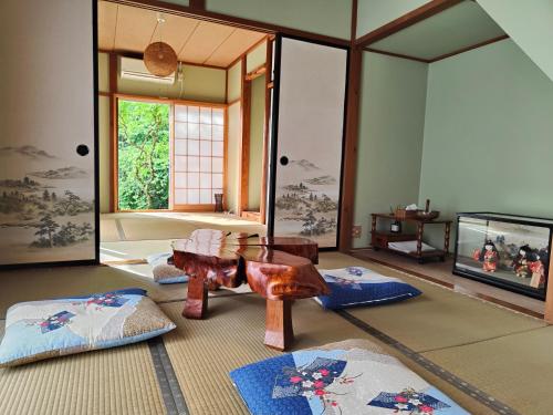 a living room with a table and a tv at 8 minutes by walk to Nikko Station Mitsuba House in Nikko
