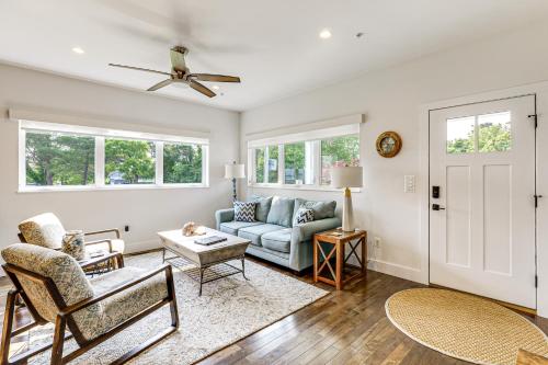 a living room with a couch and a table at Near Solomons Island Boardwalk Home with Hot Tub! in Solomons