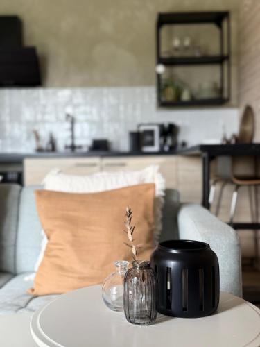 a table with a black mug on top of a table at Field View Cabin in Örebro