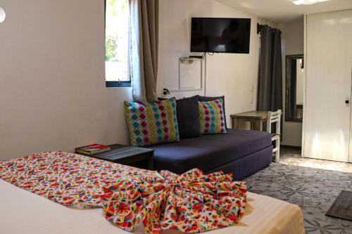 a living room with a bed and a couch at La Casita de Coyoacán in Mexico City