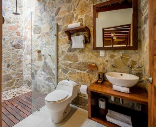a bathroom with a toilet and a sink and a shower at Casa del Mar AC Rustic design Pool Paceful in Santa María Tonameca