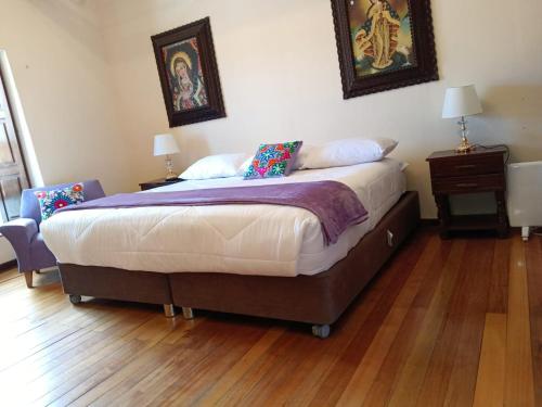 a bedroom with a bed and a wooden floor at Casona Tupac Hotel Cusco in Cusco