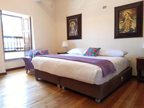 a bedroom with a large bed in a room at Casona Tupac Hotel Cusco in Cusco