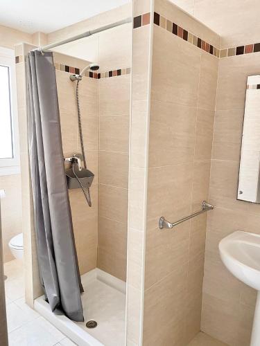 a shower with a glass door in a bathroom at Venezuela 20-22 in La Línea de la Concepción