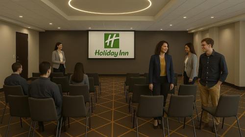 a group of people standing in a conference room at Holiday Inn & Suites Mississauga West - Meadowvale by IHG in Mississauga