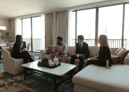 a group of people sitting on a couch in a room at The Westin Bayshore, Vancouver in Vancouver