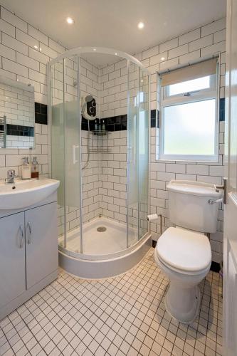 a bathroom with a shower and a toilet and a sink at Oak Cabin Overlooking Bedgebury Forest in Goudhurst