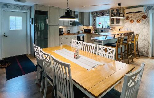 a kitchen with a wooden dining table and chairs at Amazing Home In Uddevalla With Wifi in Uddevalla