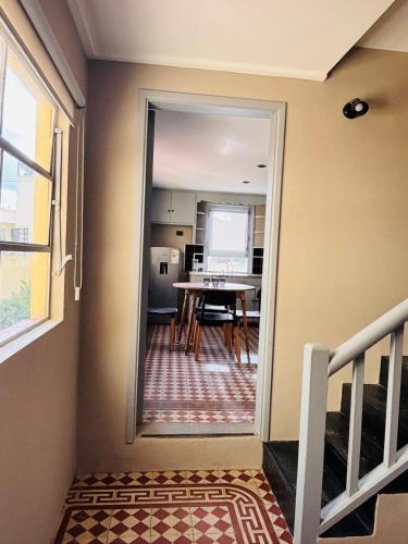 a hallway with a table and a dining room at Apartamento Penacchi in Tandil