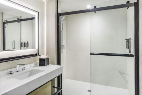 a bathroom with a sink and a shower at Sheraton Commander Hotel in Cambridge