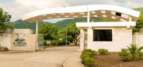 a white gas station with a white roof at Cabaña Pandu in Playa Bello Horizonte