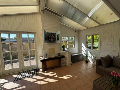 a living room with a couch and a fireplace at 6 person holiday home in Haderslev in Haderslev