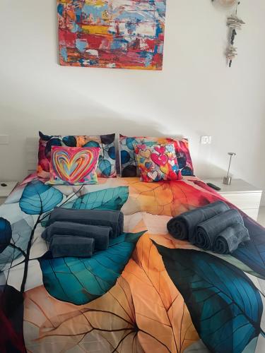 a large bed with many pillows on it at Fermata 3,5 in Sandra
