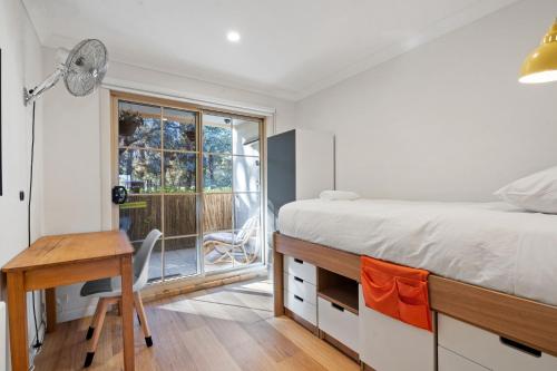 a bedroom with a bed and a desk and a window at 3-Bed Apartment in Holiday Style Resort with Pool in Watson