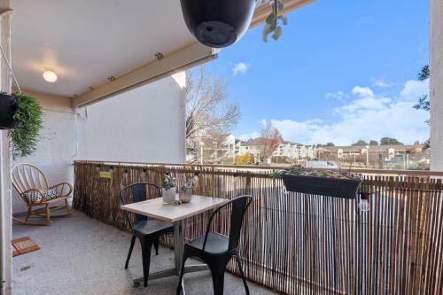 a patio with a table and chairs on a fence at 3-Bed Apartment in Holiday Style Resort with Pool in Watson