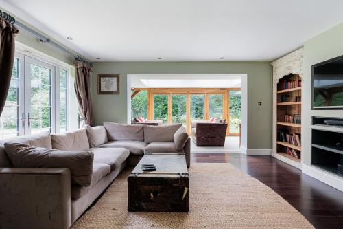 a living room with a couch and a table at Jaw Dropping House with Hot Tub & Heated Private Indoor Pool in Peover Superior
