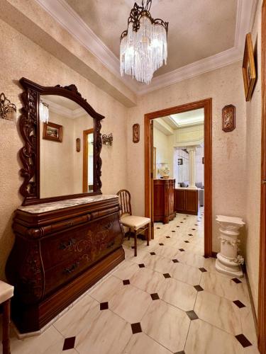 a room with a large mirror and a chair in it at Wagner Playa Apartment in Cullera