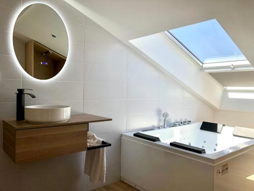 a bathroom with a sink and a mirror at A caseta de Sil in Lira