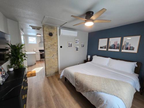 a bedroom with a bed and a ceiling fan at Stylish Modern Studio in Vibrant Walker's Point in Milwaukee