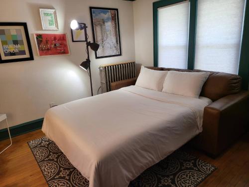 a bedroom with a large bed and a couch at Whole House in Walker's Point in Milwaukee