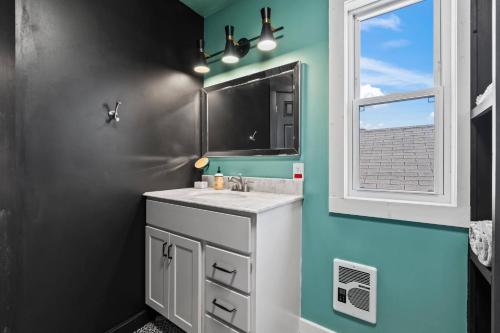 a bathroom with a sink and a mirror and a window at Whole House in Walker's Point in Milwaukee