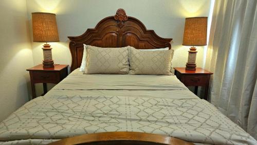 a bedroom with a bed with two lamps on tables at Nice Private Room Close to Red Rock & Las Vegas Strip #3 in Las Vegas