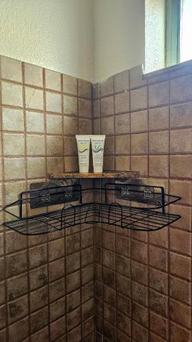 two cups sitting on a shelf in a bathroom at Nice Private Room Close to Red Rock & Las Vegas Strip #3 in Las Vegas