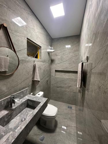 a bathroom with a toilet and a sink at Hotel Araguaia Exclusive in Aruanã