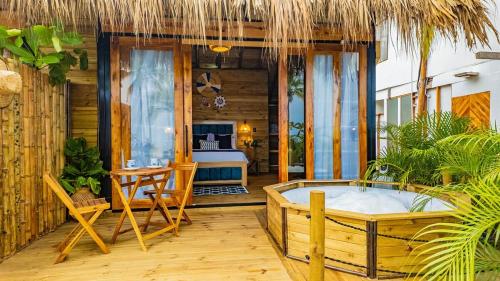 a room with a bed and a tub on a porch at Beach Suite cerca al Tayrona in Santa Marta