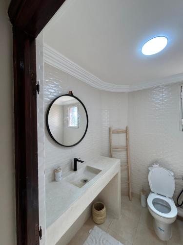 a white bathroom with a sink and a toilet at Villa moderne avec jacuzzi & jardin - Marrakech in Marrakech