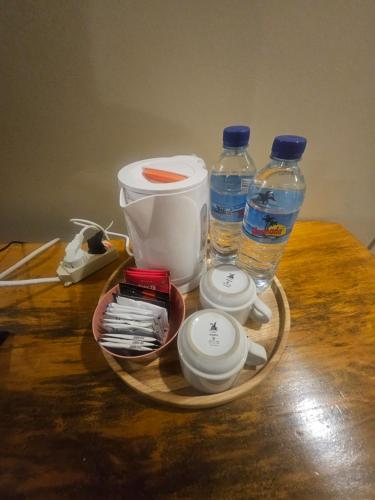 a tray with bottles of water and other items on a table at Rinjani Trekking Center in Senaru